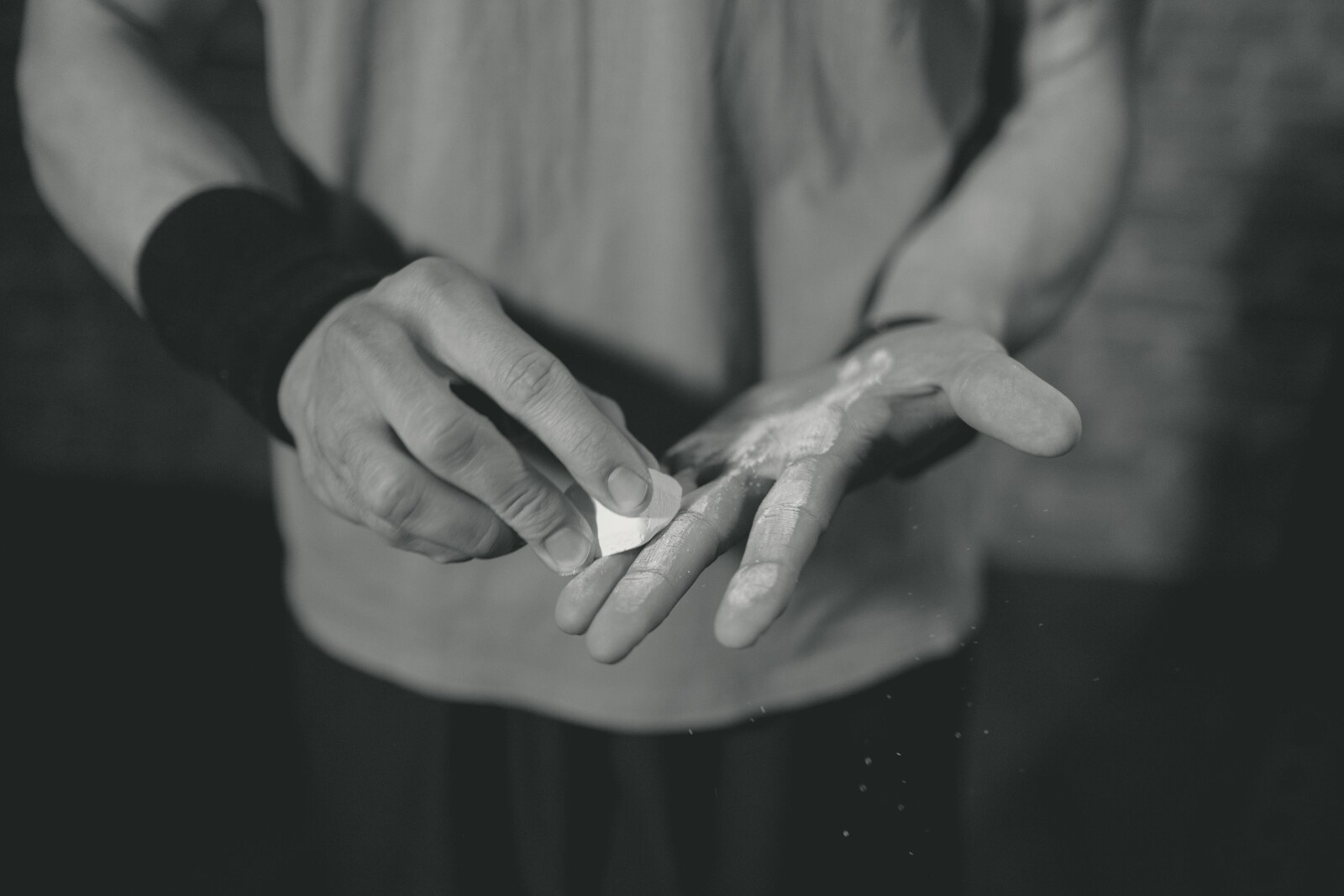 Athlete chalking hands before training