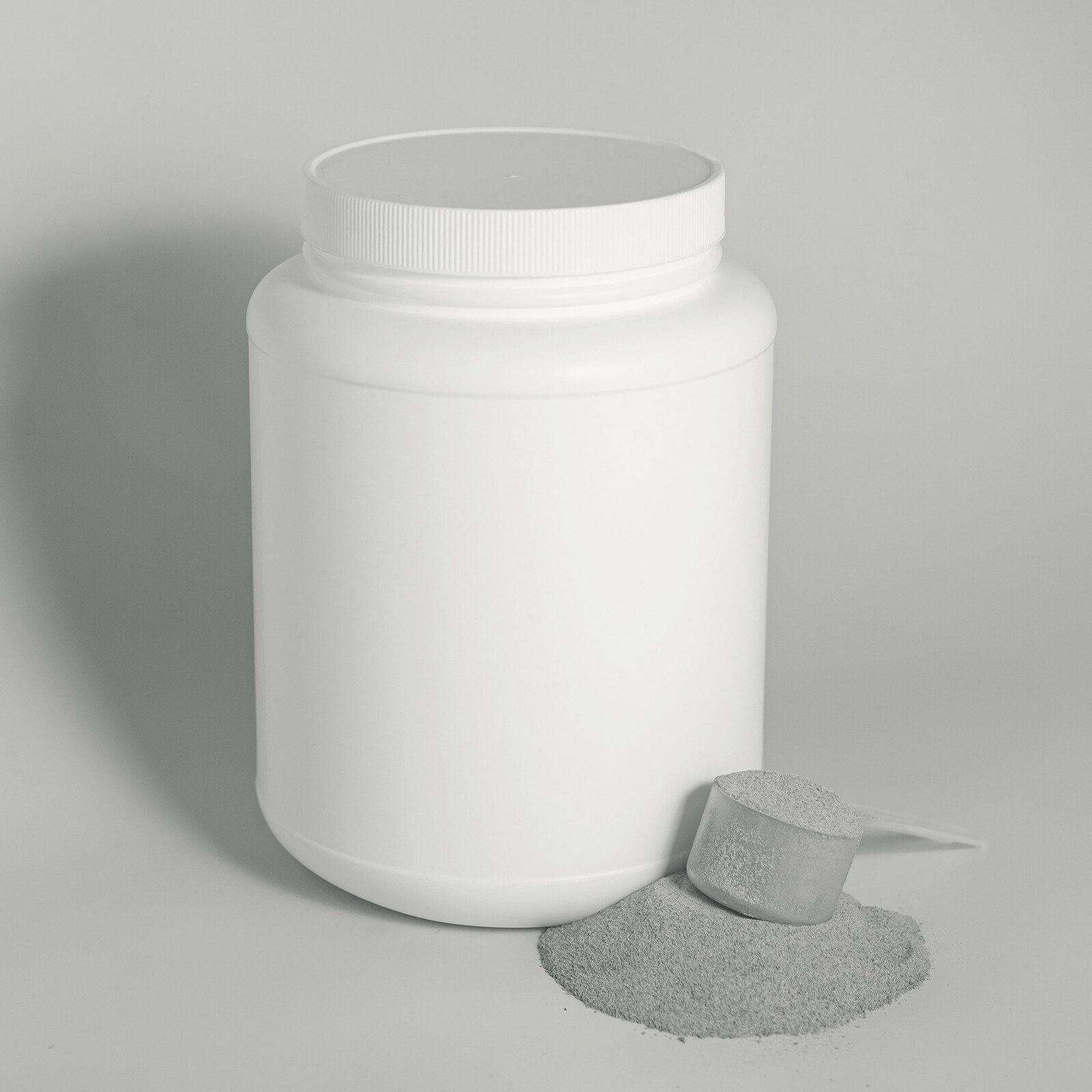 Tub of protein powder with scoop