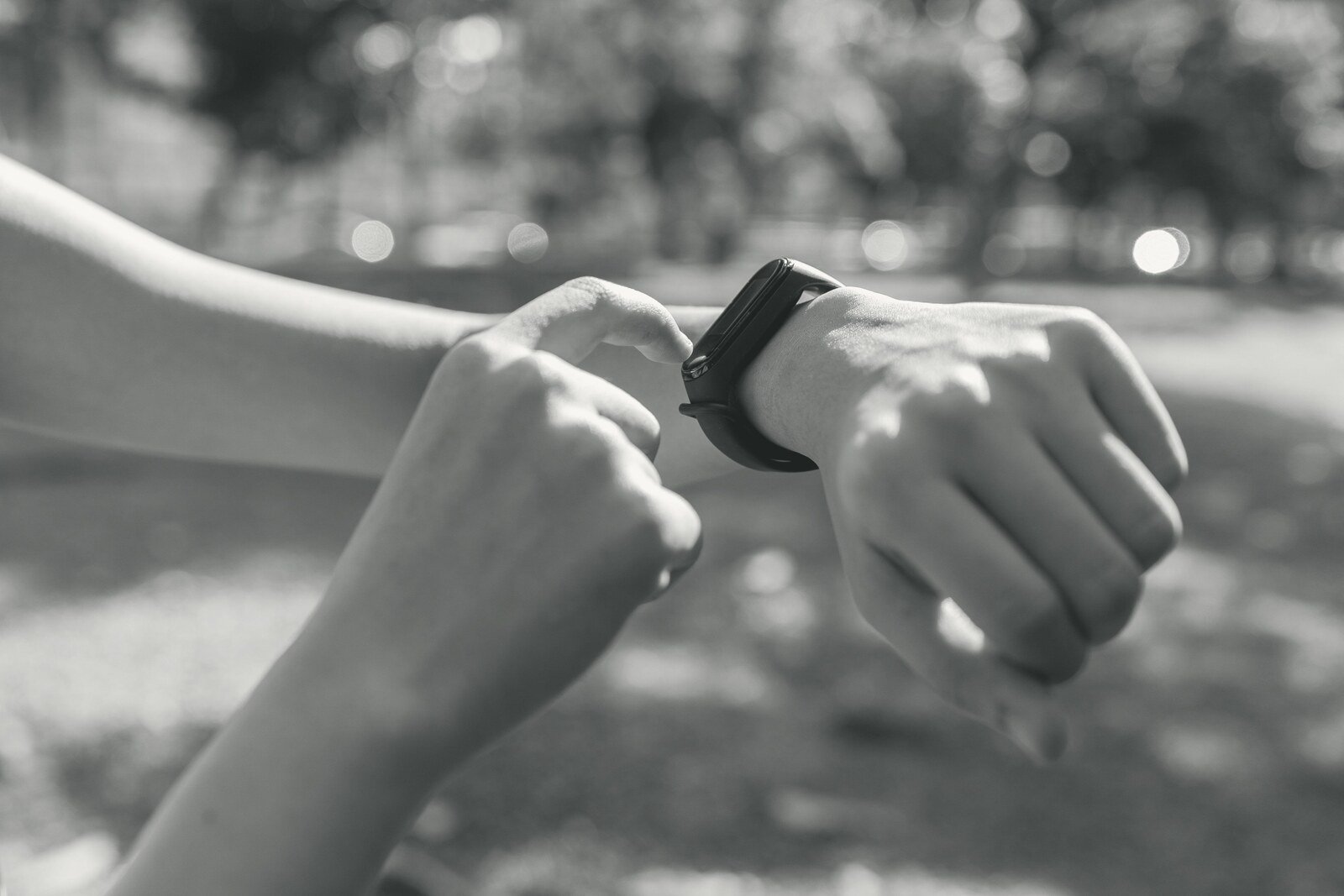 Person checking fitness watch outdoors